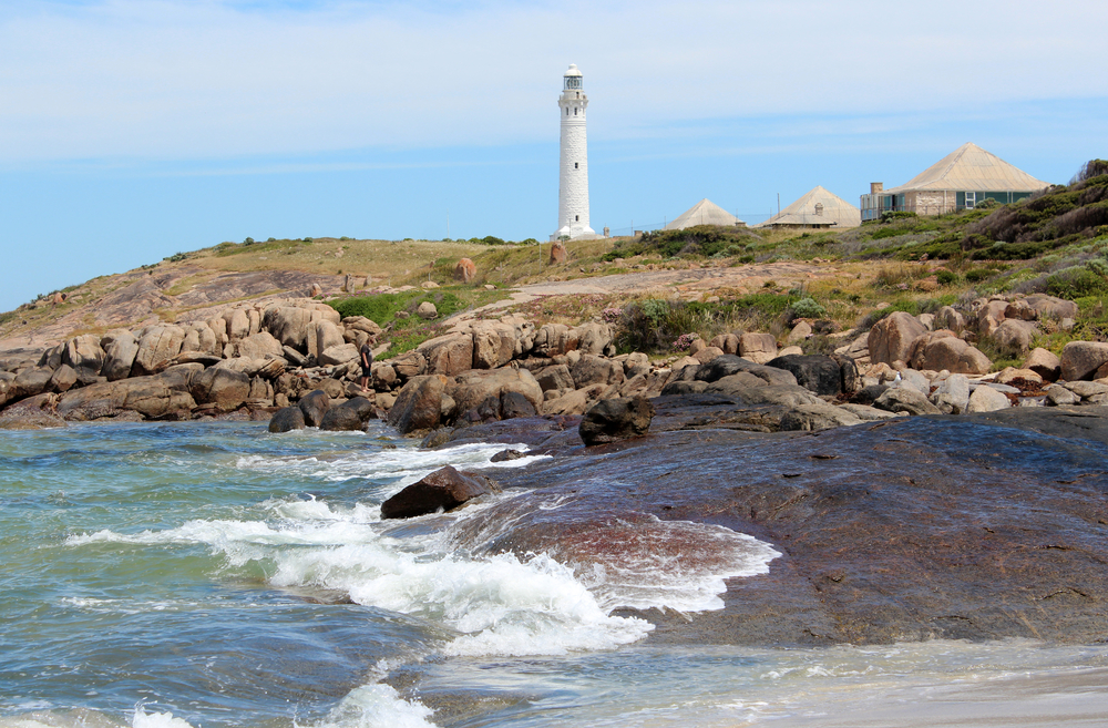 Waves splash against rocks on a Cape Leeuwin Lighthouse tour in Margaret River - Harvest Tours