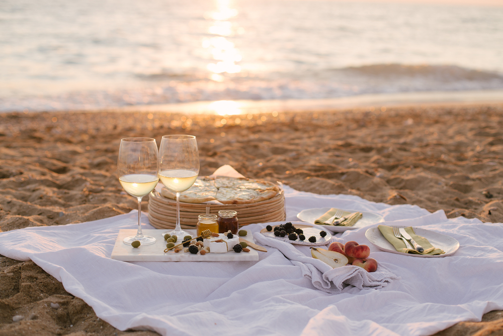 sunset picnic with wine on the beach