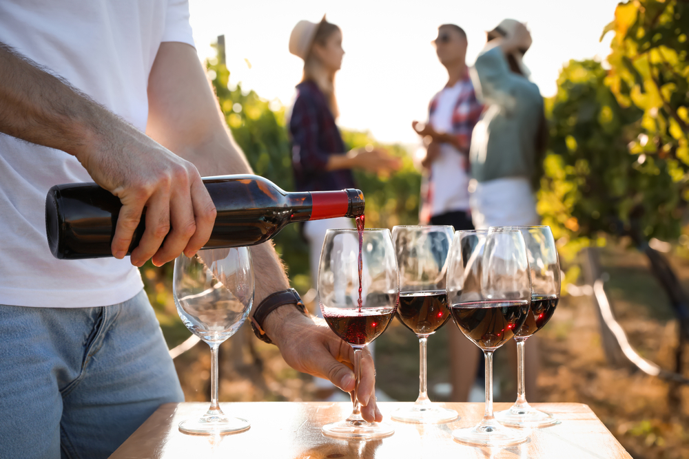 Man pouring wine into wine glasses in Margaret River